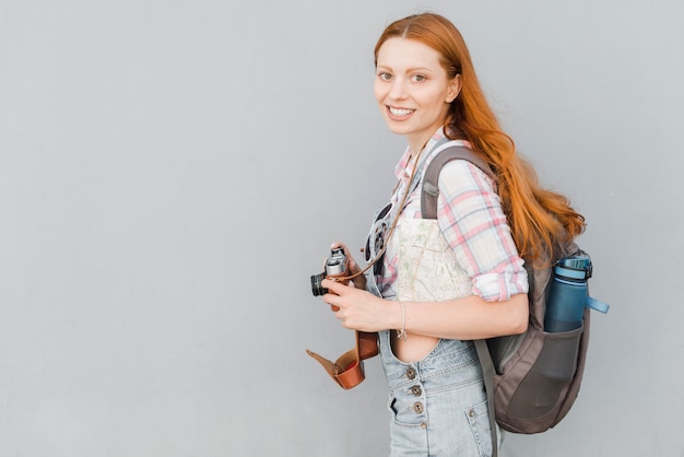 Free photo traveler with camera and backpack