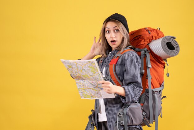 traveler woman in confusion with backpack holding map