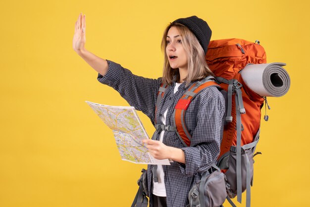 traveler woman with backpack holding map hailing someone
