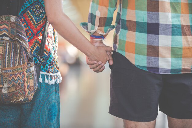 Travelers join hands while traveling to the train station.