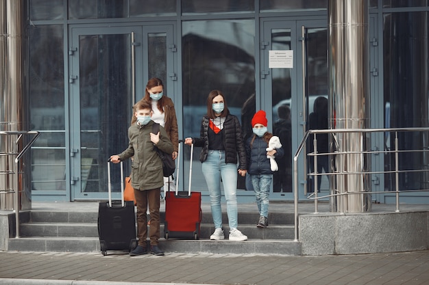 공항을 떠나는 여행자는 보호 마스크를 착용하고 있습니다