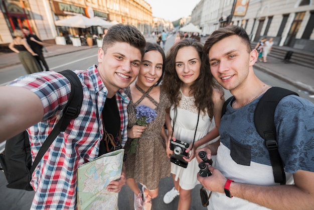 Travelers taking selfie on street