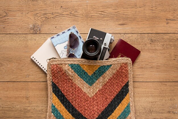 Traveling items on wooden background flat lay