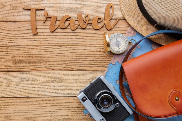 Traveling items on wooden background flat lay