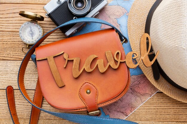 Traveling items on wooden background top view