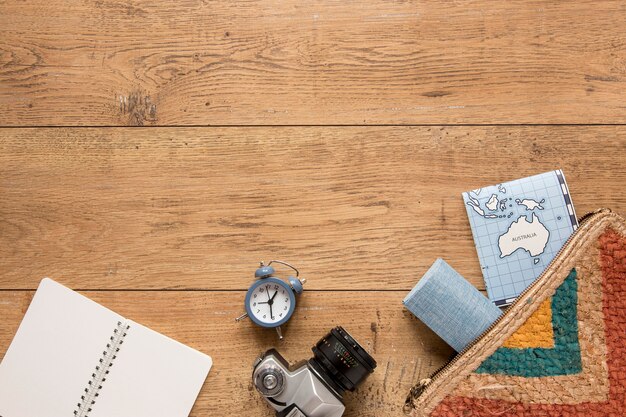 Traveling items on wooden background above view