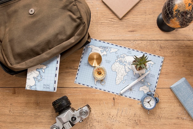 Free photo traveling items on wooden background