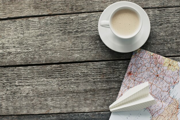 Traveling map, paper plane and coffee cup