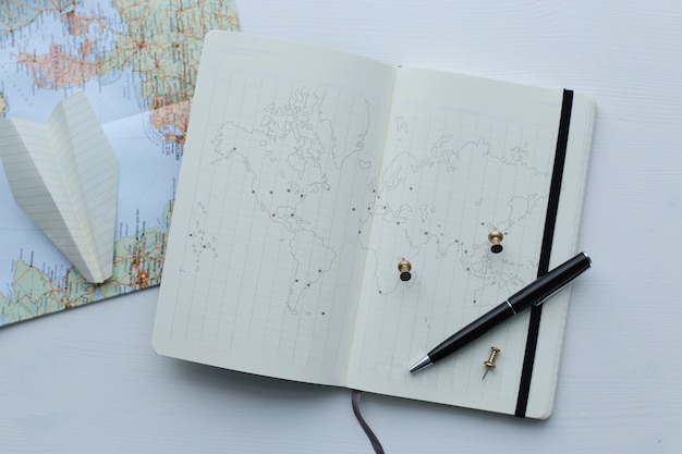 Traveling map, paper plane and diary