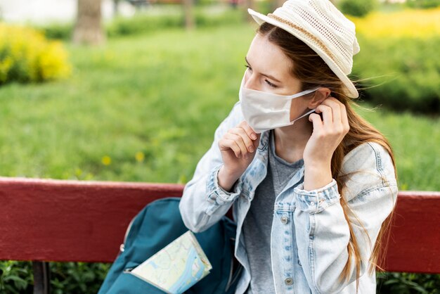 Traveller arranging her medical mask