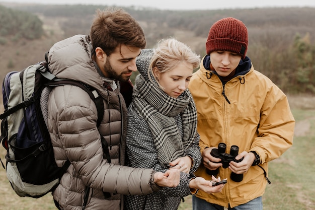 Traveller friends looking at compass