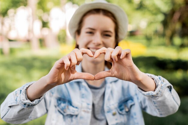 Traveller in the park making a heart shape