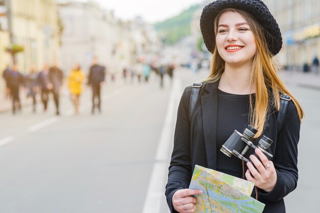 Traveller with binoculars and map