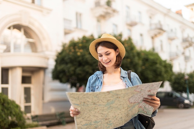 Traveller with hat checking local map