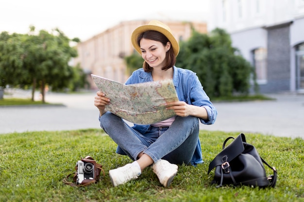 Traveller with hat checking local map