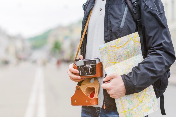 Free Photo traveller with map and camera on street