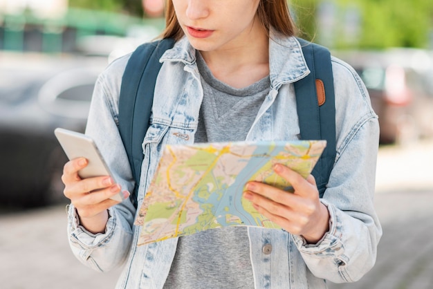 Traveller with map and mobile phone