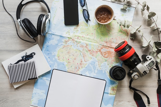 Travelling accessories over the map on the table