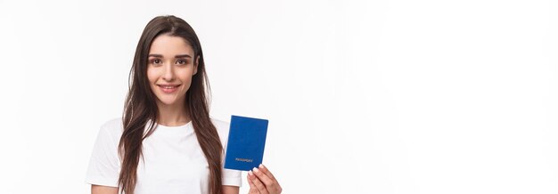 Travelling holidays summer concept closeup portrait of caucasian smiling happy woman in tshirt holdi