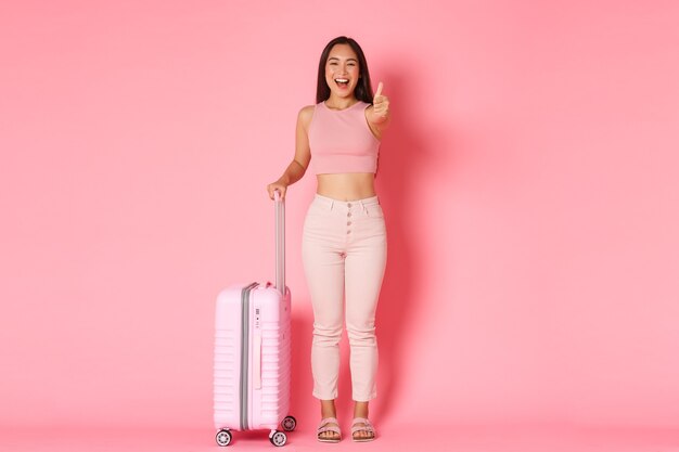 Travelling, holidays and vacation concept. Cheerful smiling, attractive asian girl in summer clothes