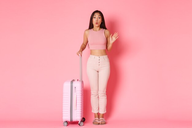 Travelling, holidays and vacation concept. Silly and cute asian girl in summer clothes meeting girlfriends in airport