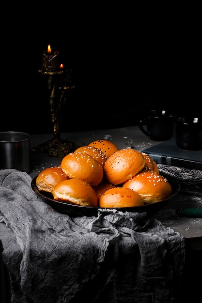 A tray of burger buns sprinkled with sesame and black seed