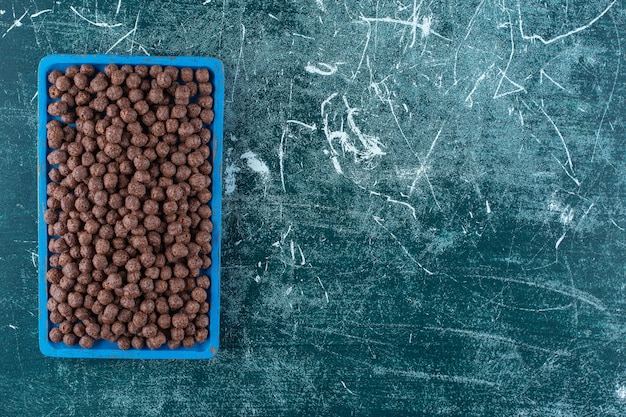 A tray of corn balls , on the blue background. High quality photo