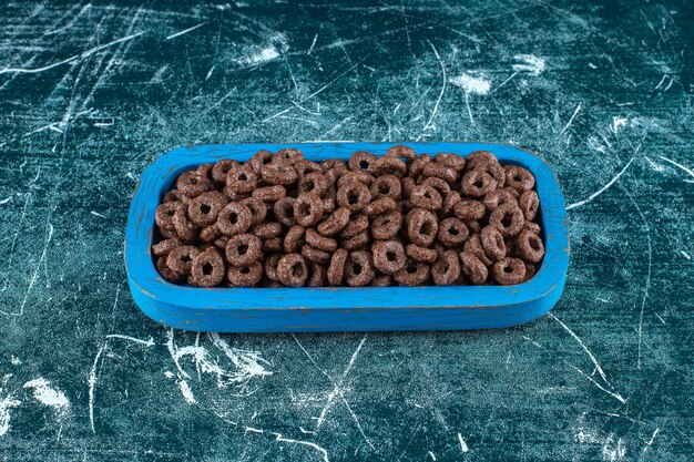 A tray of corn rings , on the blue background. High quality photo