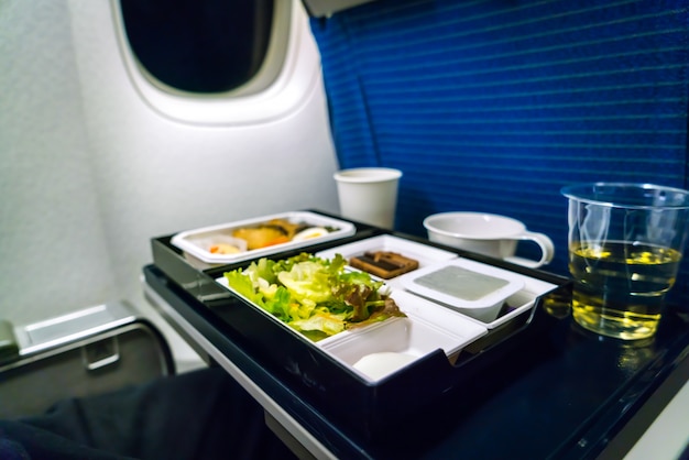 Tray of food on plane .