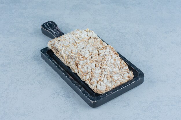 A tray of puffed rice cakes on marble.