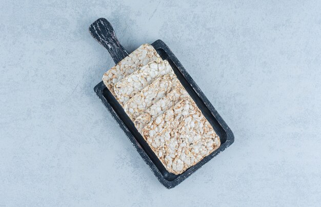 A tray of puffed rice cakes on marble.