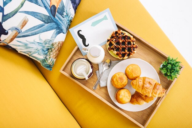 Tray with breakfast on sofa