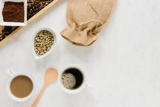 Tray with coffee beans and coffee cups