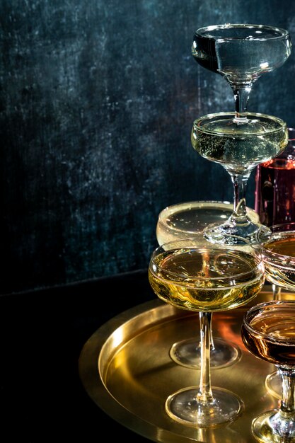 Tray with glasses with drinks on table