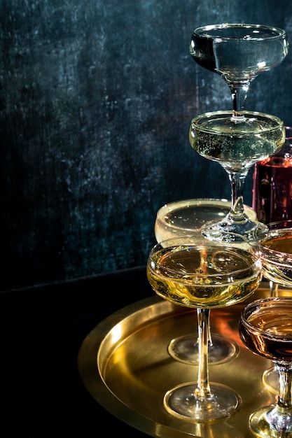 Tray with glasses with drinks on table