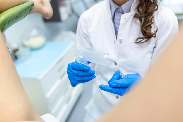 Treatment of cervical disease Female gynecologist woman patient in gynecological chair during check up with gynecological speculum