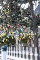 Free photo tree decorated with colorful easter eggs street easter decor