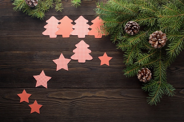 Free photo trees cut out with stars on a dark wooden table