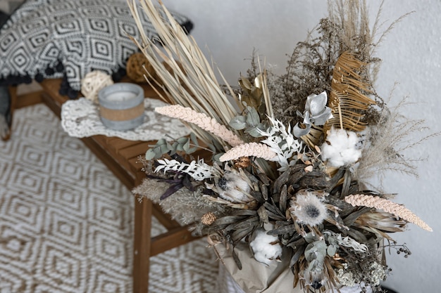 Free photo trendy composition of dried flowers, home decor, a long-lasting gift of flowers and herbs.