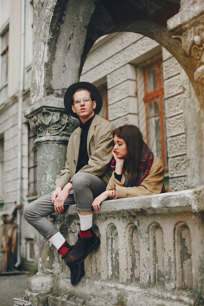 A trendy couple in a gloomy city