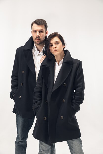 Trendy fashionable couple isolated on white studio background.