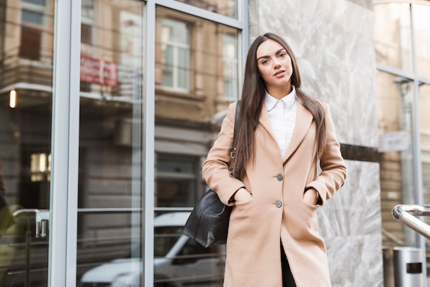 Trendy girl standing on street