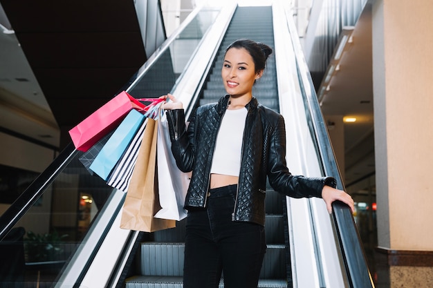 Trendy model holding pile of paper bags