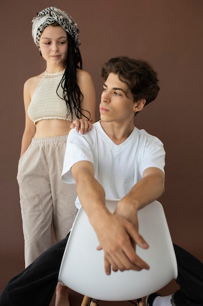 Trendy teenager boy and girl posing together