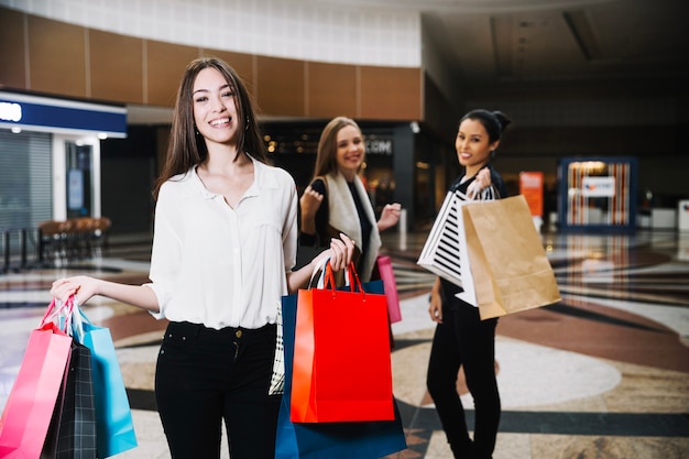 Trendy woman with bags in mall