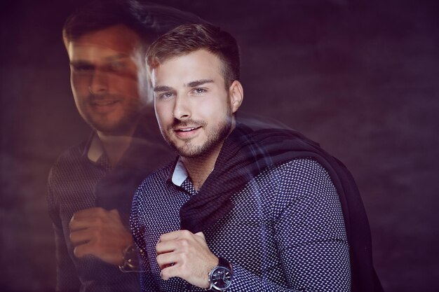 Trendy young man in shirt with jacket on his shoulder.