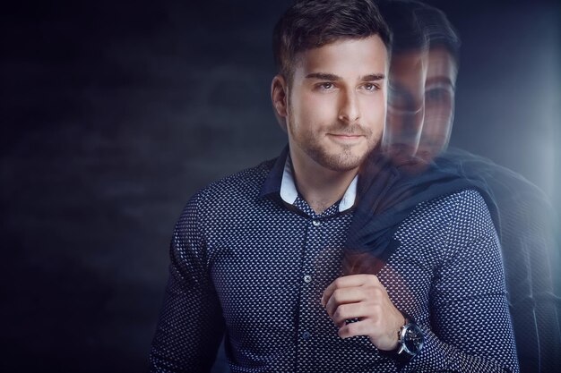 Trendy young man in shirt with jacket on his shoulder.