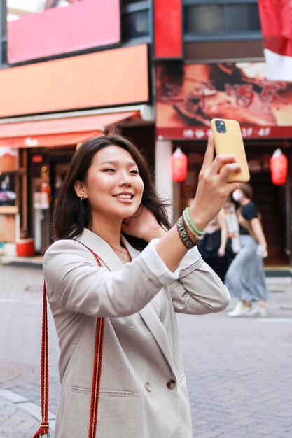 Trendy young woman taking a selfie