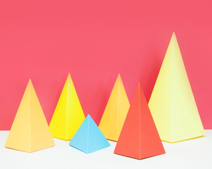 मुफ़्त फोटो triangle geometric paper shape pack on desk