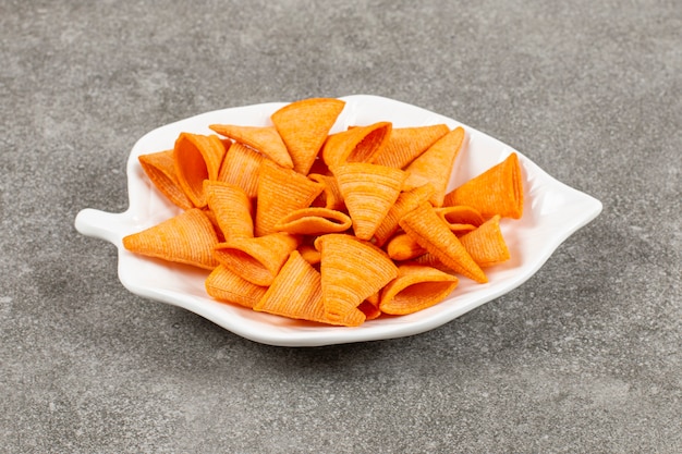 Triangle shape chips on white plate.